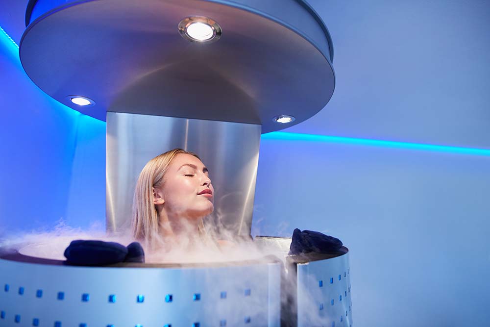 A young woman undergoes a procedure in a cryo sauna.